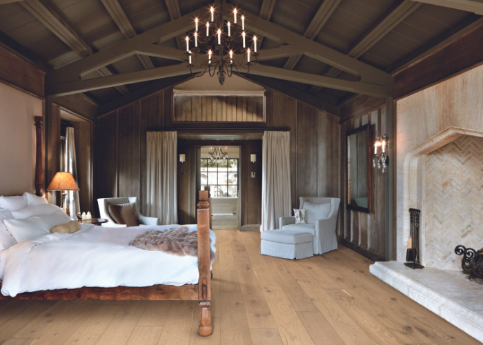 Neutral hardwood flooring in a rustic bedroom.